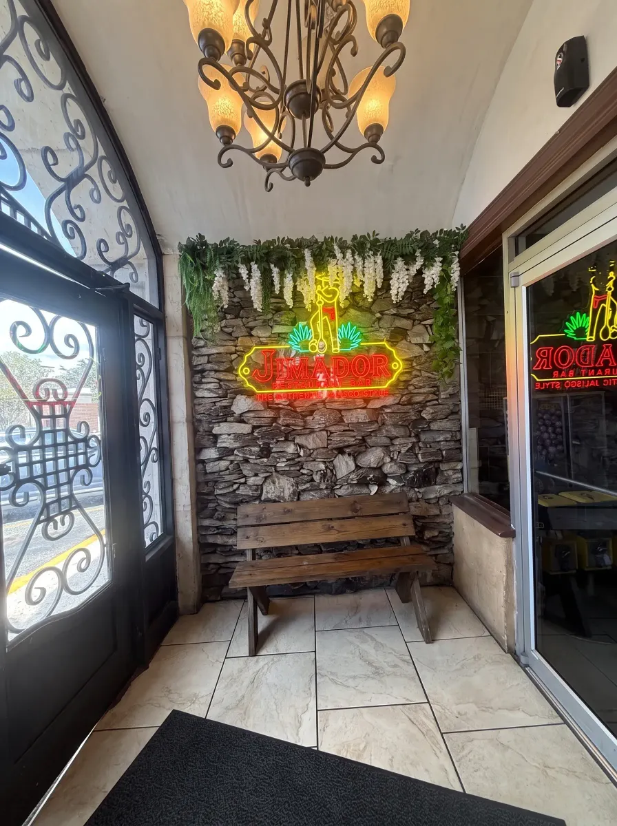 Neon sign glowing at the restaurant entrance after dark